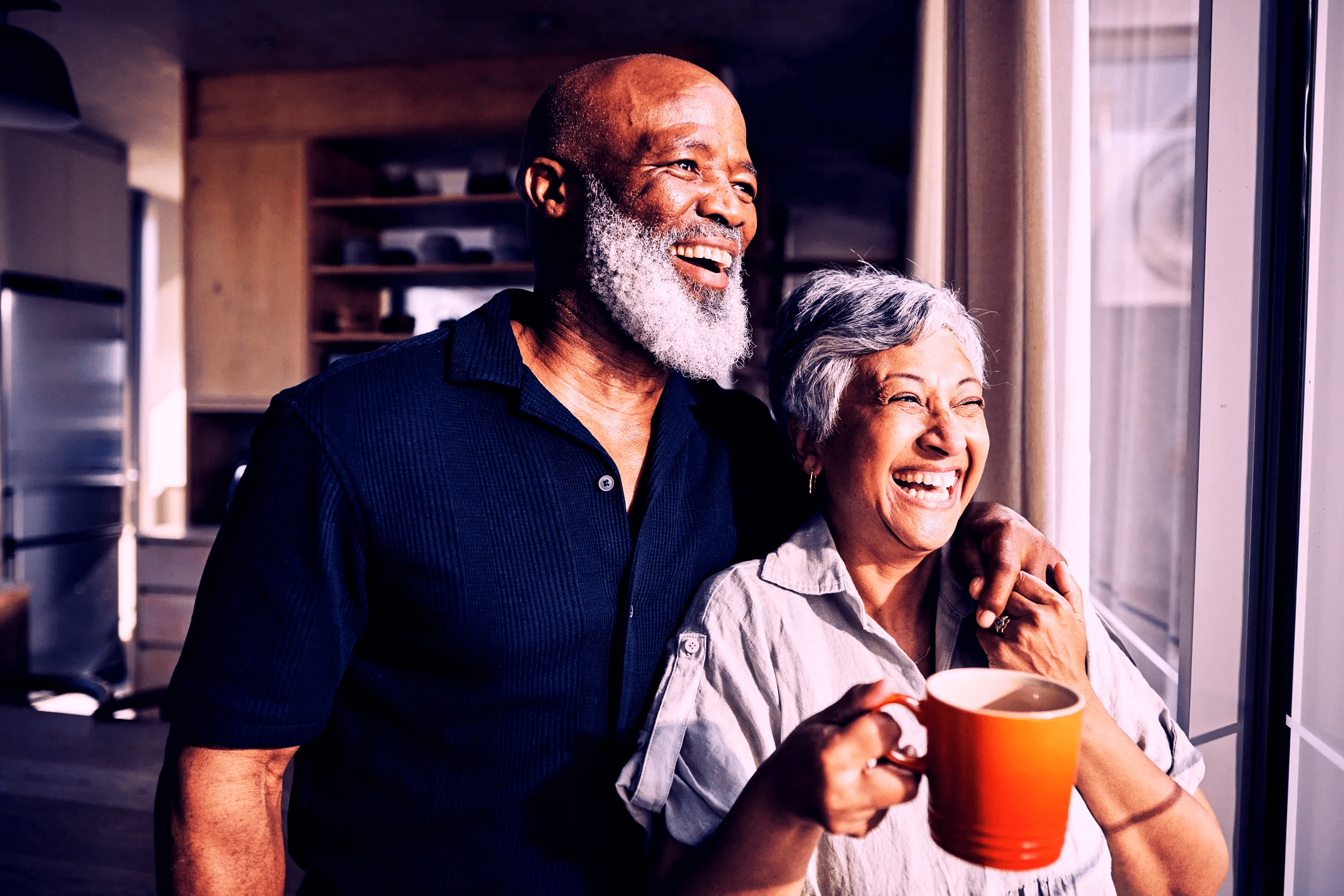 Older couple looking peacefully out of a window