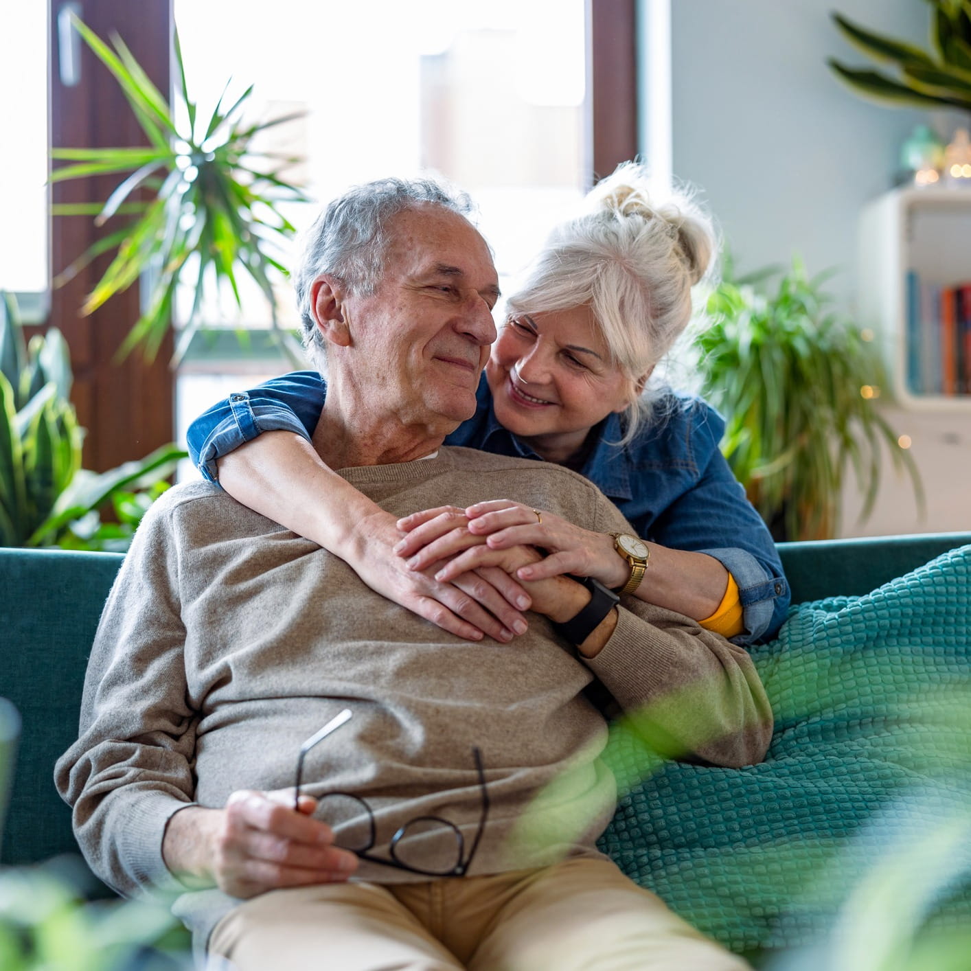 Elderly couple embracing gently